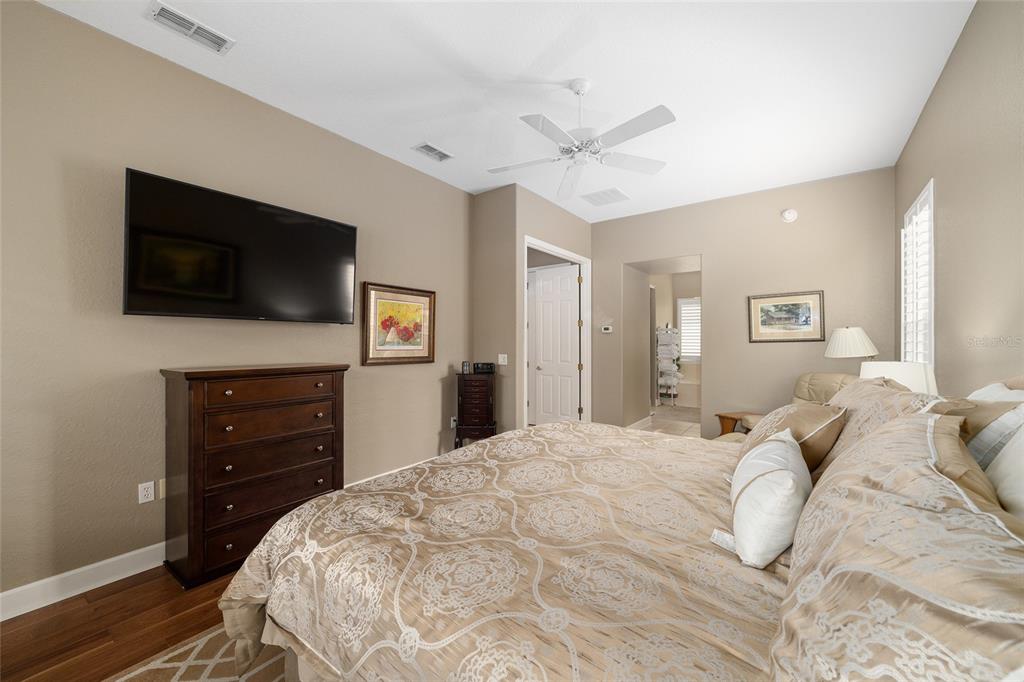 9479 Southeast 130th Street Road Summerfield, FL 34491 - Photo 22 of 67 a bedroom with a bed and a flat screen tv
