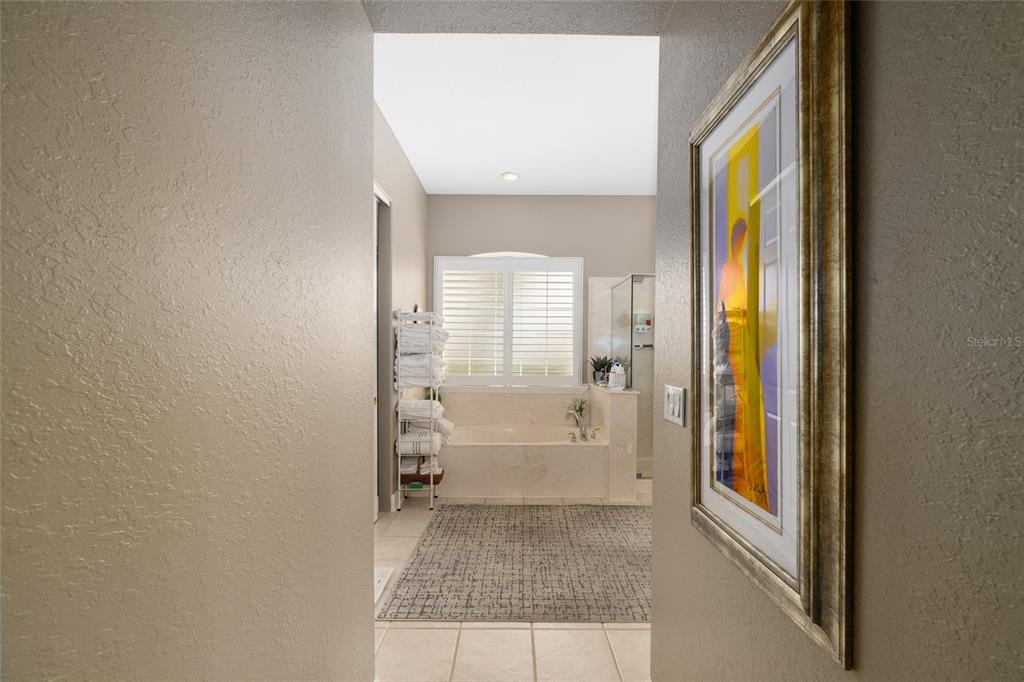 9479 Southeast 130th Street Road Summerfield, FL 34491 - Photo 23 of 67 a view of a bathroom from a hallway