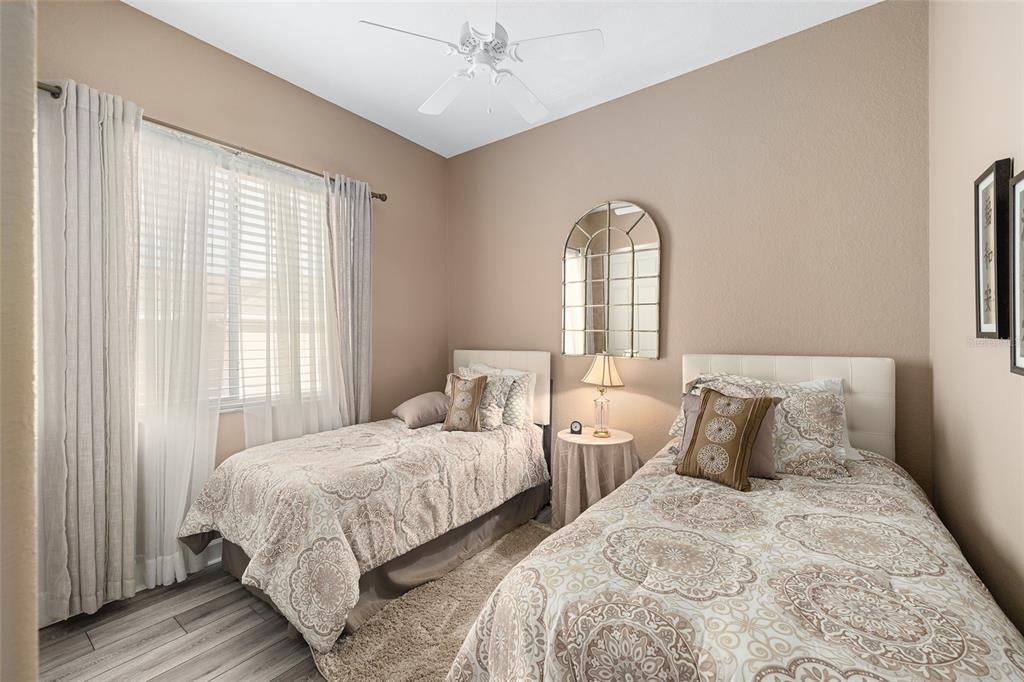 9479 Southeast 130th Street Road Summerfield, FL 34491 - Photo 28 of 67 a bedroom with two beds and a window