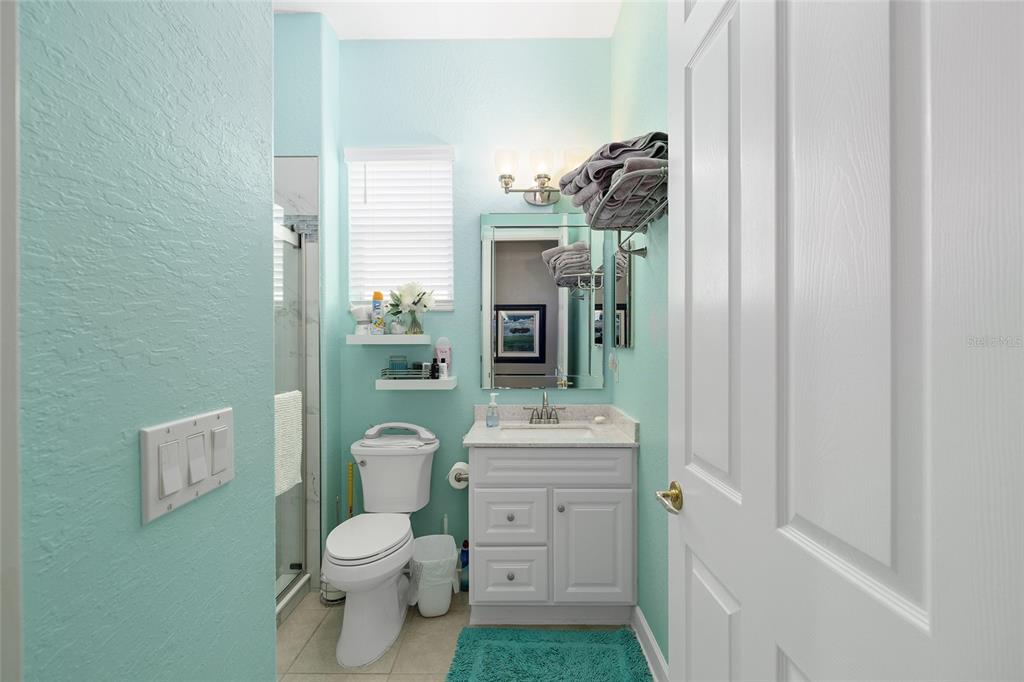 9479 Southeast 130th Street Road Summerfield, FL 34491 - Photo 29 of 67 a bathroom with a toilet a sink and shower