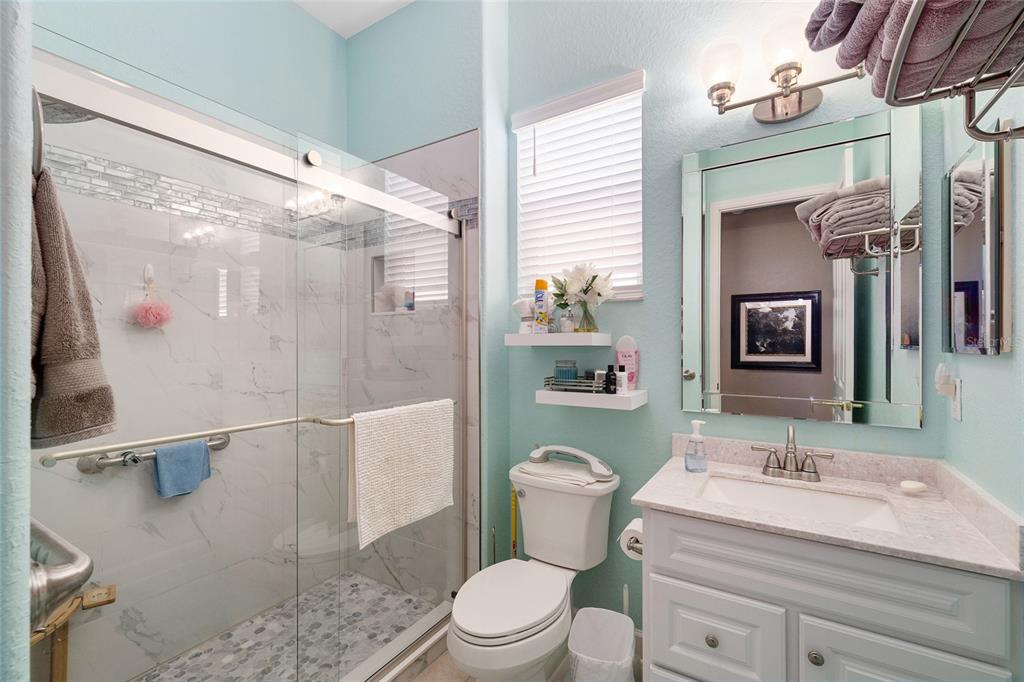 9479 Southeast 130th Street Road Summerfield, FL 34491 - Photo 30 of 67 a bathroom with a sink a toilet and shower