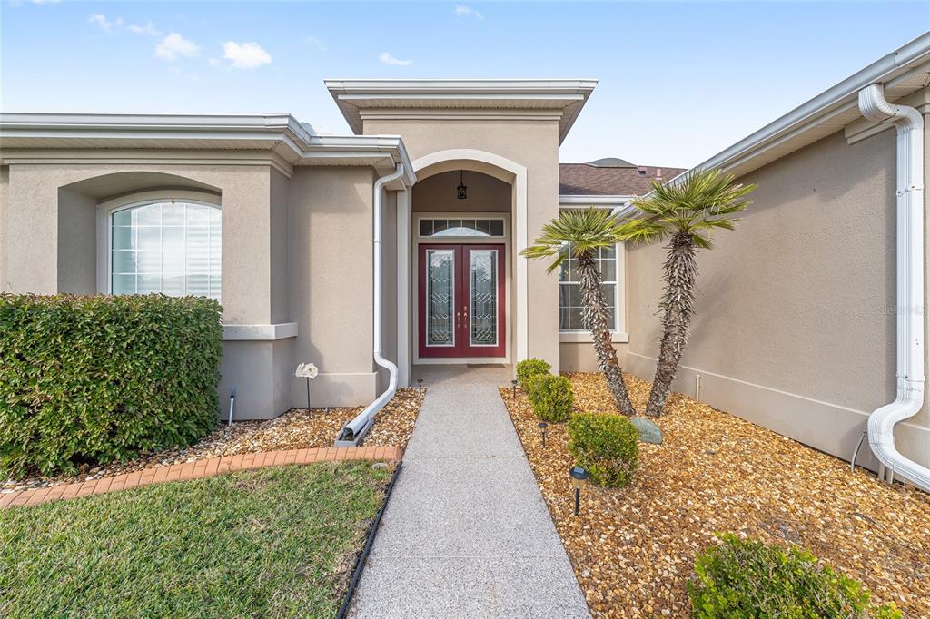 9479 Southeast 130th Street Road Summerfield, FL 34491 - Photo 3 of 67 a front view of a house with garden