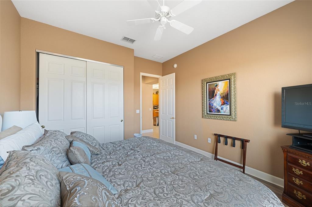 9479 Southeast 130th Street Road Summerfield, FL 34491 - Photo 32 of 67 a bedroom with a bed and a flat screen tv