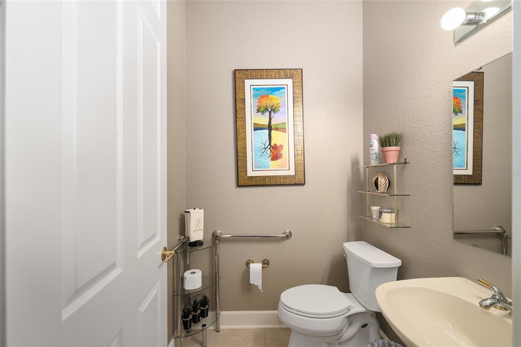 9479 Southeast 130th Street Road Summerfield, FL 34491 - Photo 33 of 67 a bathroom with a toilet a sink and mirror