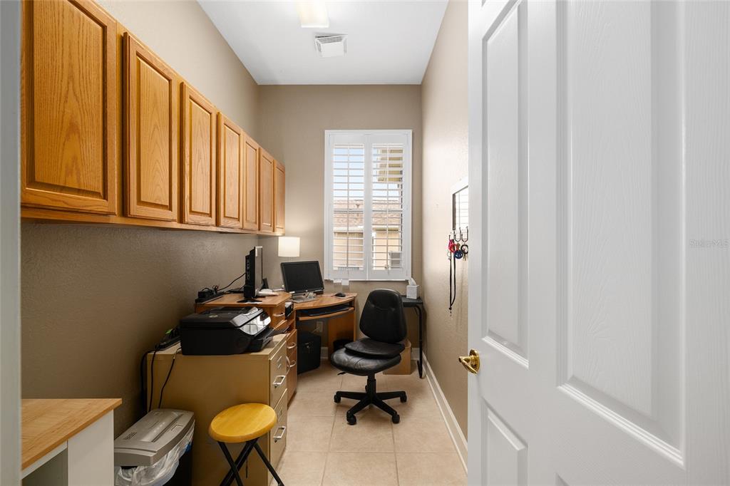 9479 Southeast 130th Street Road Summerfield, FL 34491 - Photo 35 of 67 a view of a workspace with furniture and a window