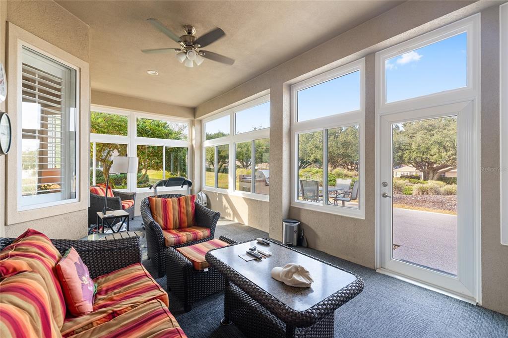 9479 Southeast 130th Street Road Summerfield, FL 34491 - Photo 37 of 67 a living room with furniture and floor to ceiling windows