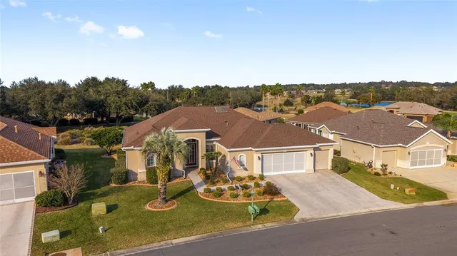 an aerial view of a house with garden space lake view and mountain view in back