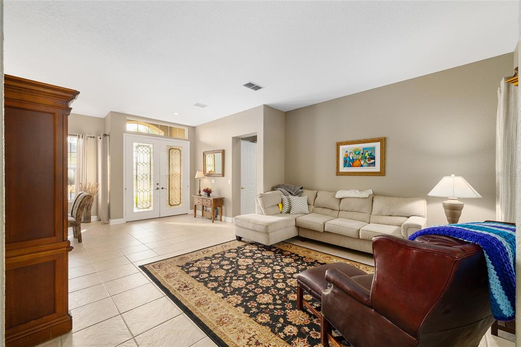 9479 Southeast 130th Street Road Summerfield, FL 34491 - Photo 7 of 67 a living room with furniture and a rug