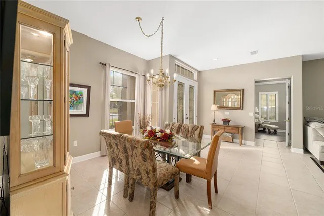 a dining room with furniture a chandelier and wooden floor