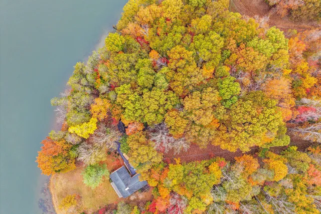 an aerial view of residential house with outdoor space and lake view
