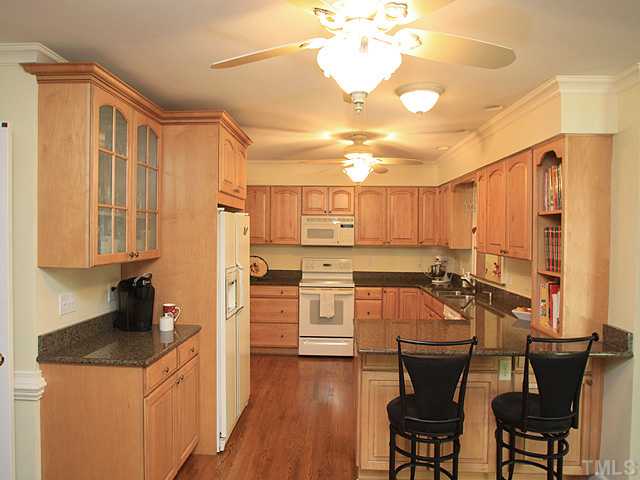 8224 Morgans Way Raleigh, NC 27613 - Photo 1 of 3 a kitchen with stainless steel appliances kitchen island granite countertop a sink and cabinets