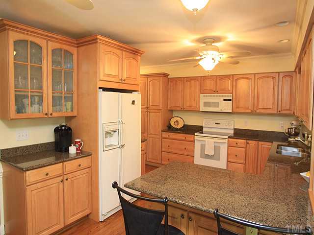 8224 Morgans Way Raleigh, NC 27613 - Photo 2 of 3 a kitchen with stainless steel appliances granite countertop a stove refrigerator sink and cabinets