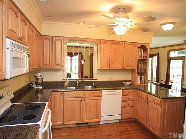 8224 Morgans Way Raleigh, NC 27613 - Photo 3 of 3 a kitchen with stainless steel appliances granite countertop a sink stove and cabinets