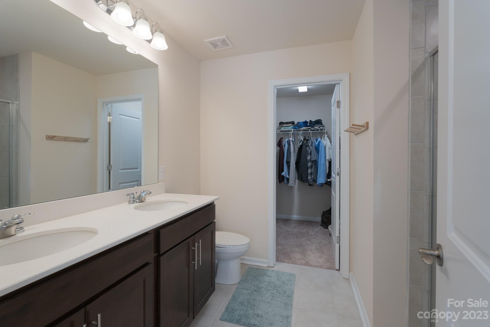 467 Hunters Dance Road Fort Mill, SC 29708 - Photo 13 of 28 a en suite bathroom with a granite countertop sink a toilet and a mirror