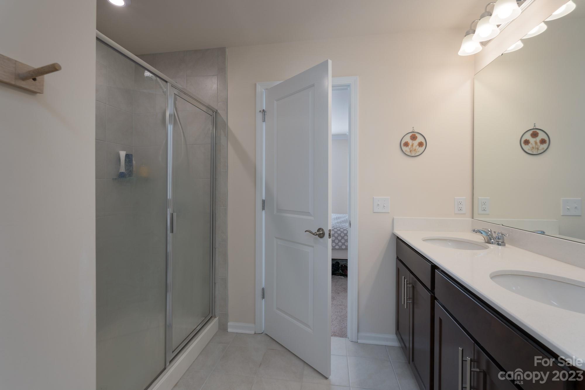 467 Hunters Dance Road Fort Mill, SC 29708 - Photo 14 of 28 a bathroom with a double vanity sink mirror and shower