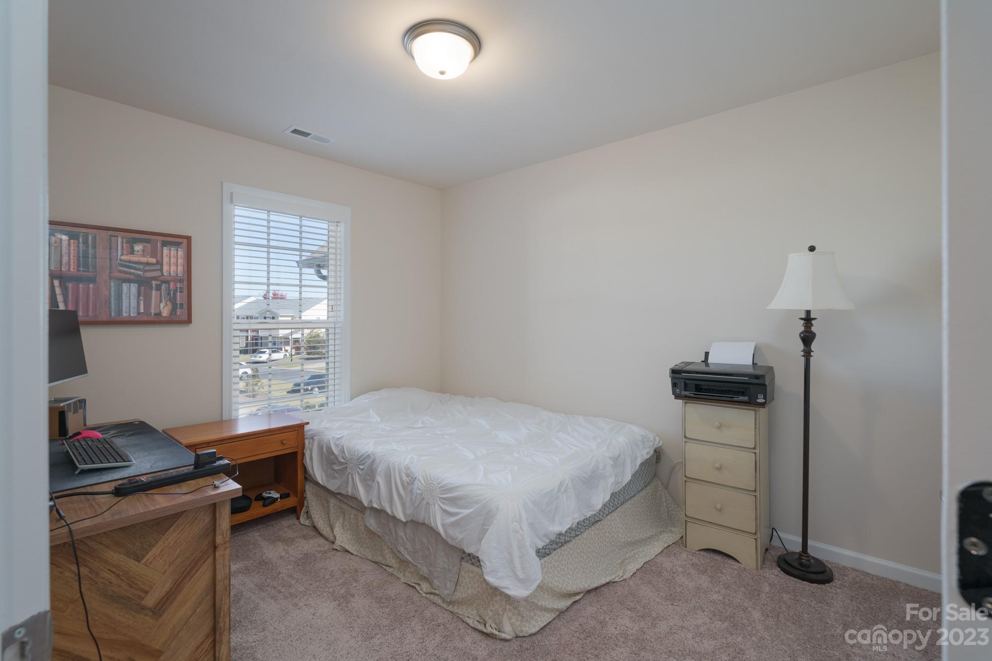 467 Hunters Dance Road Fort Mill, SC 29708 - Photo 15 of 28 a bedroom with a bed and a table in it