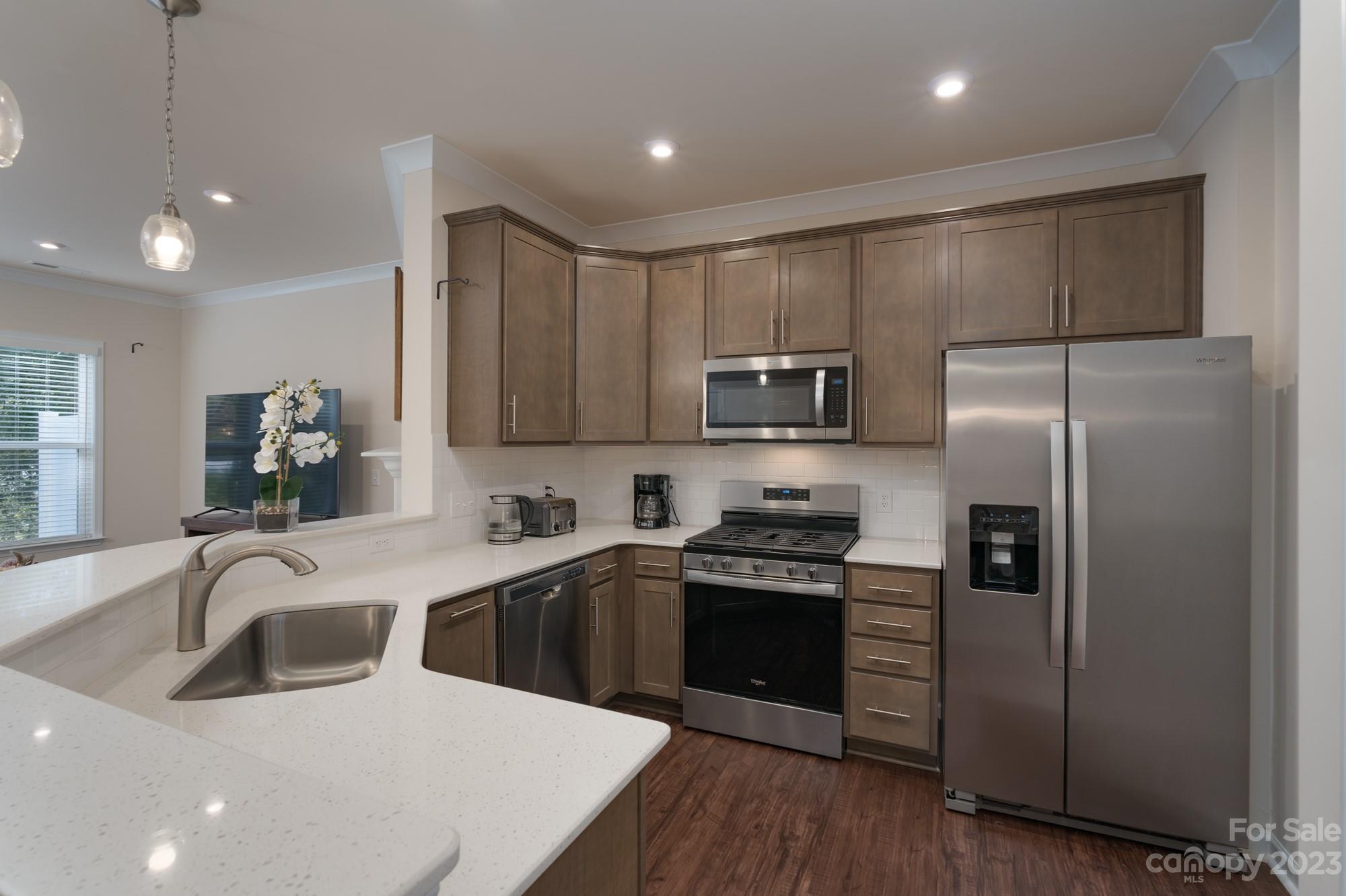 467 Hunters Dance Road Fort Mill, SC 29708 - Photo 5 of 28 a kitchen with stainless steel appliances granite countertop a sink stove and refrigerator