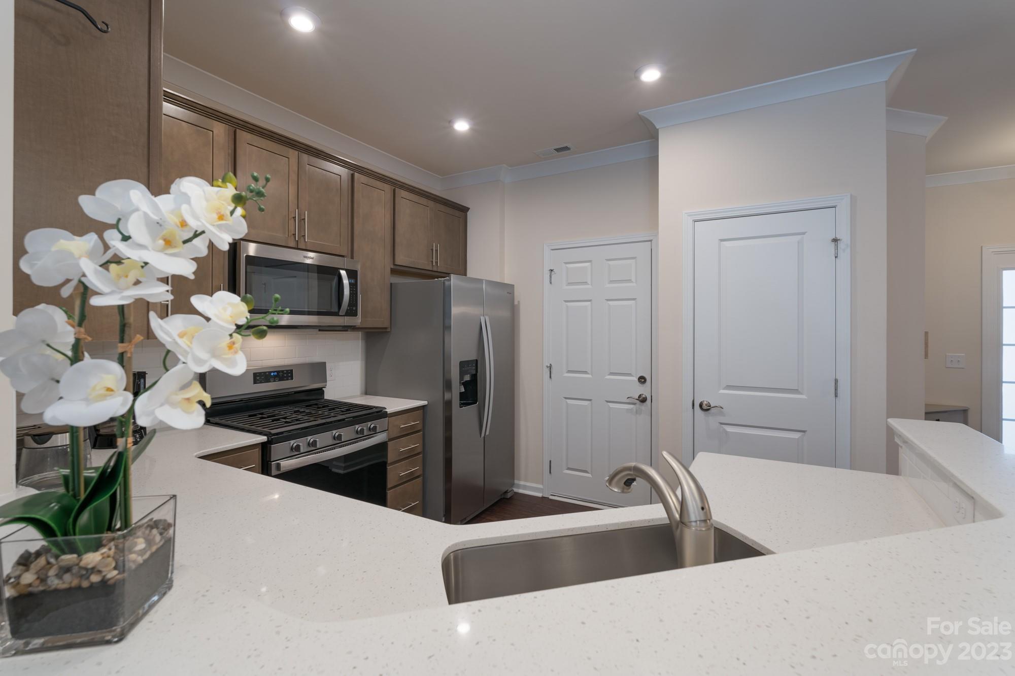 467 Hunters Dance Road Fort Mill, SC 29708 - Photo 6 of 28 a kitchen with stainless steel appliances a sink a refrigerator a stove and a white cabinets