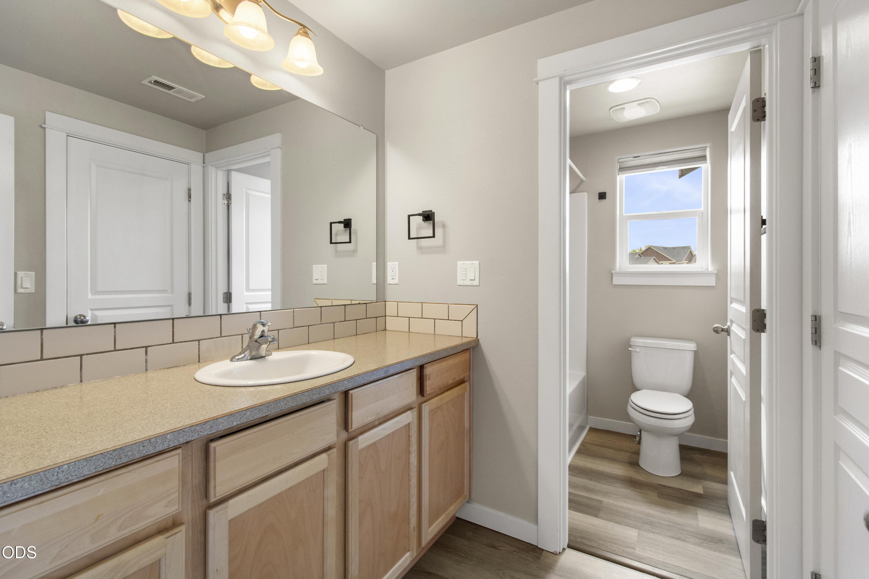21332 Oconnor Way Bend, OR 97701 - Photo 23 of 33 a bathroom with a granite countertop sink toilet and mirror