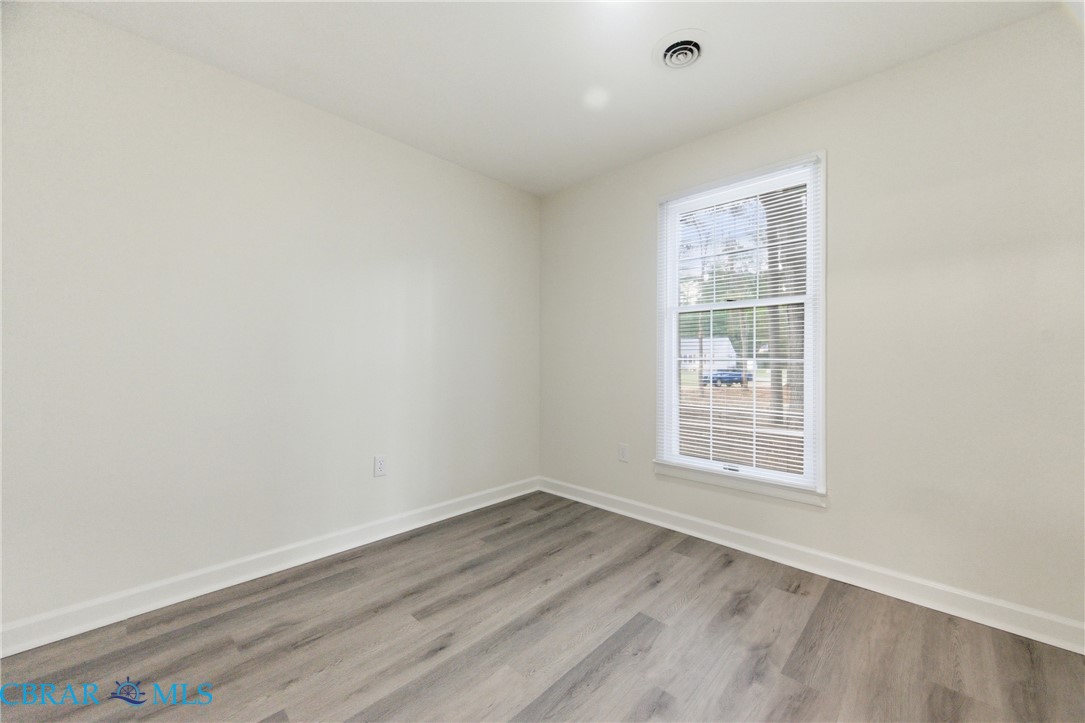 718 Dandy Loop Road Yorktown, VA 23692 - Photo 18 of 42 Spare room with wood finished floors and baseboards