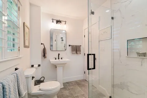 a bathroom with a toilet sink and shower