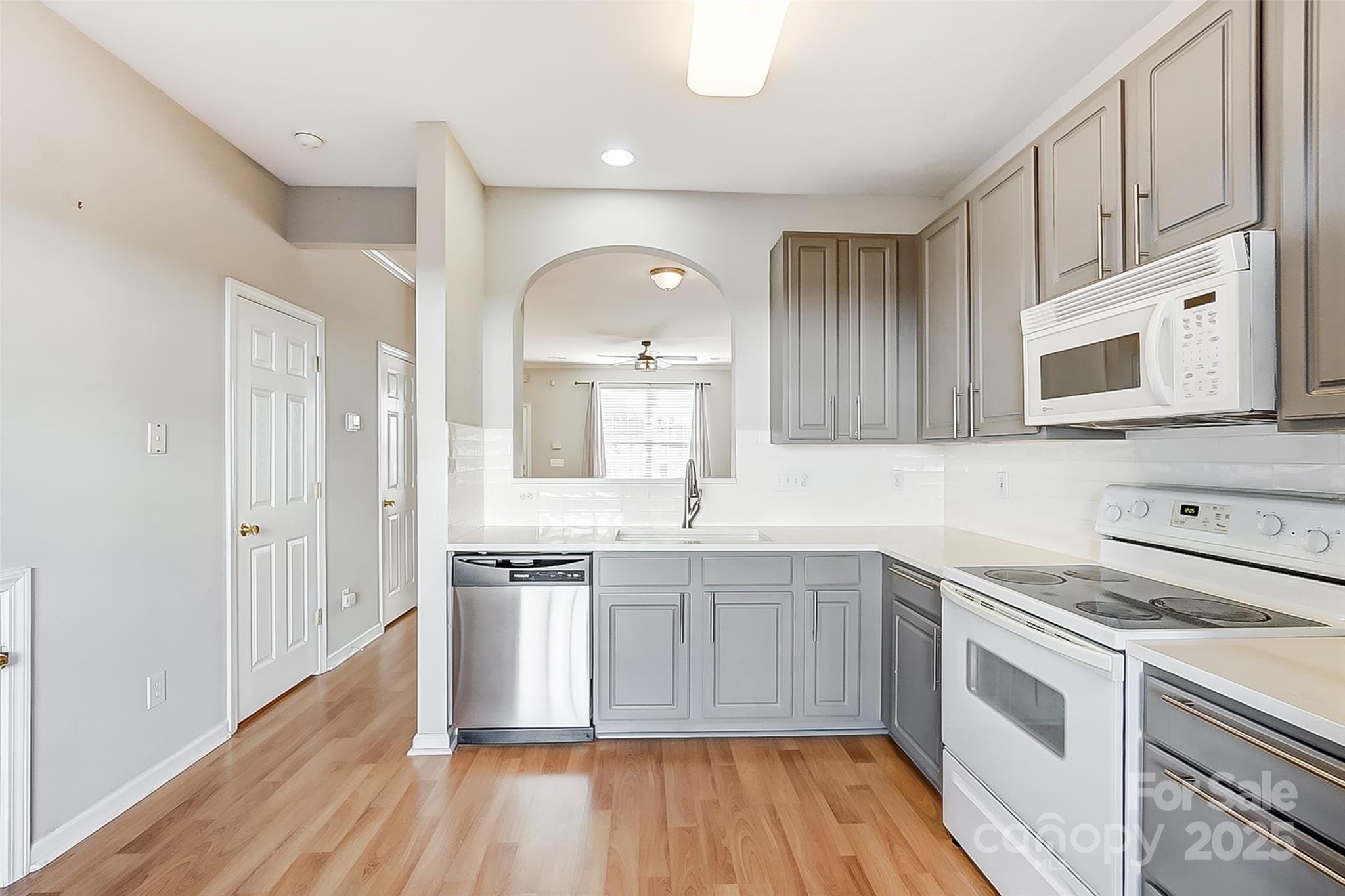 928 Azurine Circle Fort Mill, SC 29708 - Photo 14 of 33 a kitchen with stainless steel appliances granite countertop a sink and stove top oven