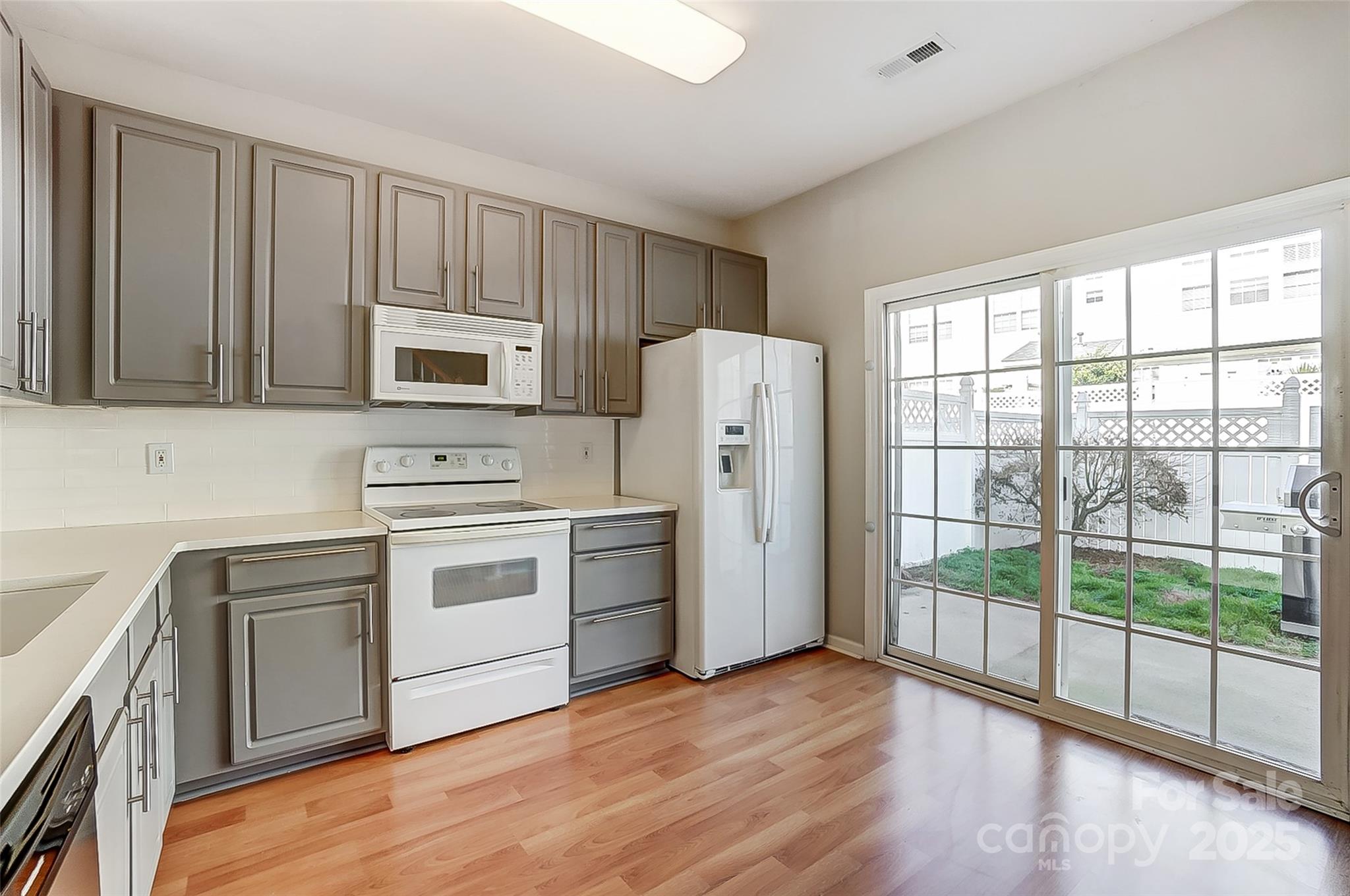 928 Azurine Circle Fort Mill, SC 29708 - Photo 16 of 33 a kitchen with a refrigerator stove and wooden cabinets