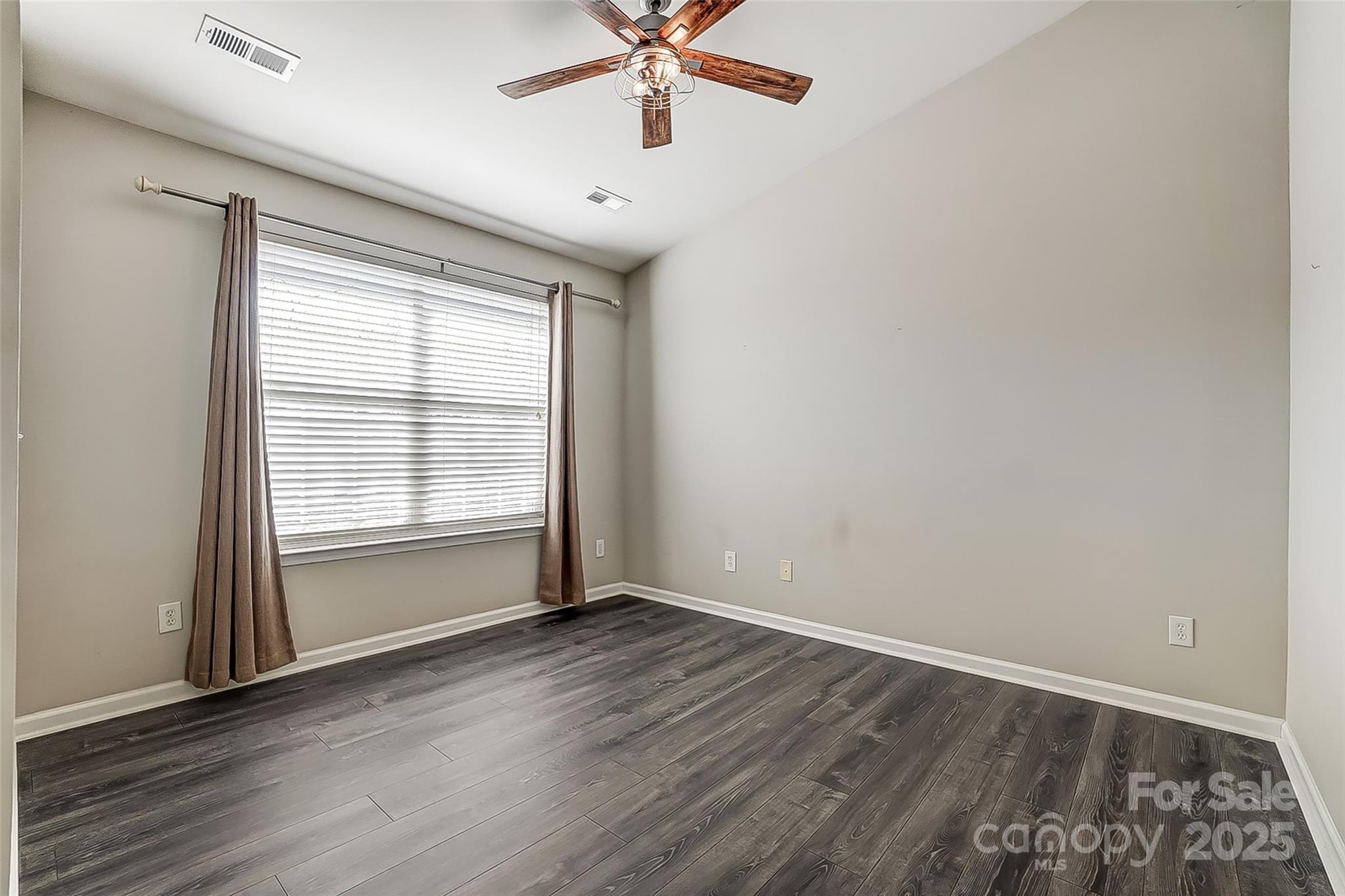 928 Azurine Circle Fort Mill, SC 29708 - Photo 22 of 33 an empty room with wooden floor fan and windows
