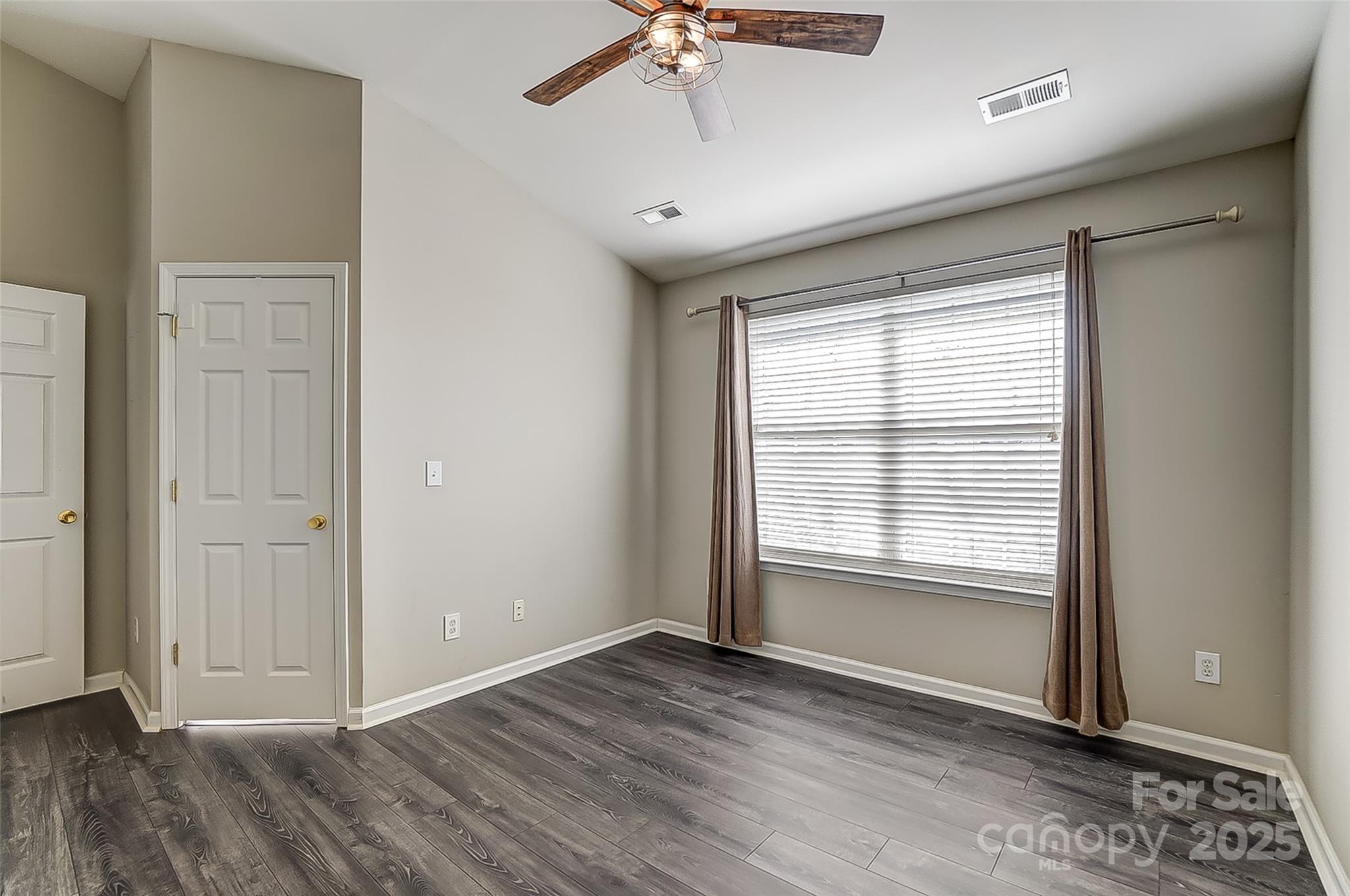 928 Azurine Circle Fort Mill, SC 29708 - Photo 23 of 33 a view of an empty room with a window and wooden floor