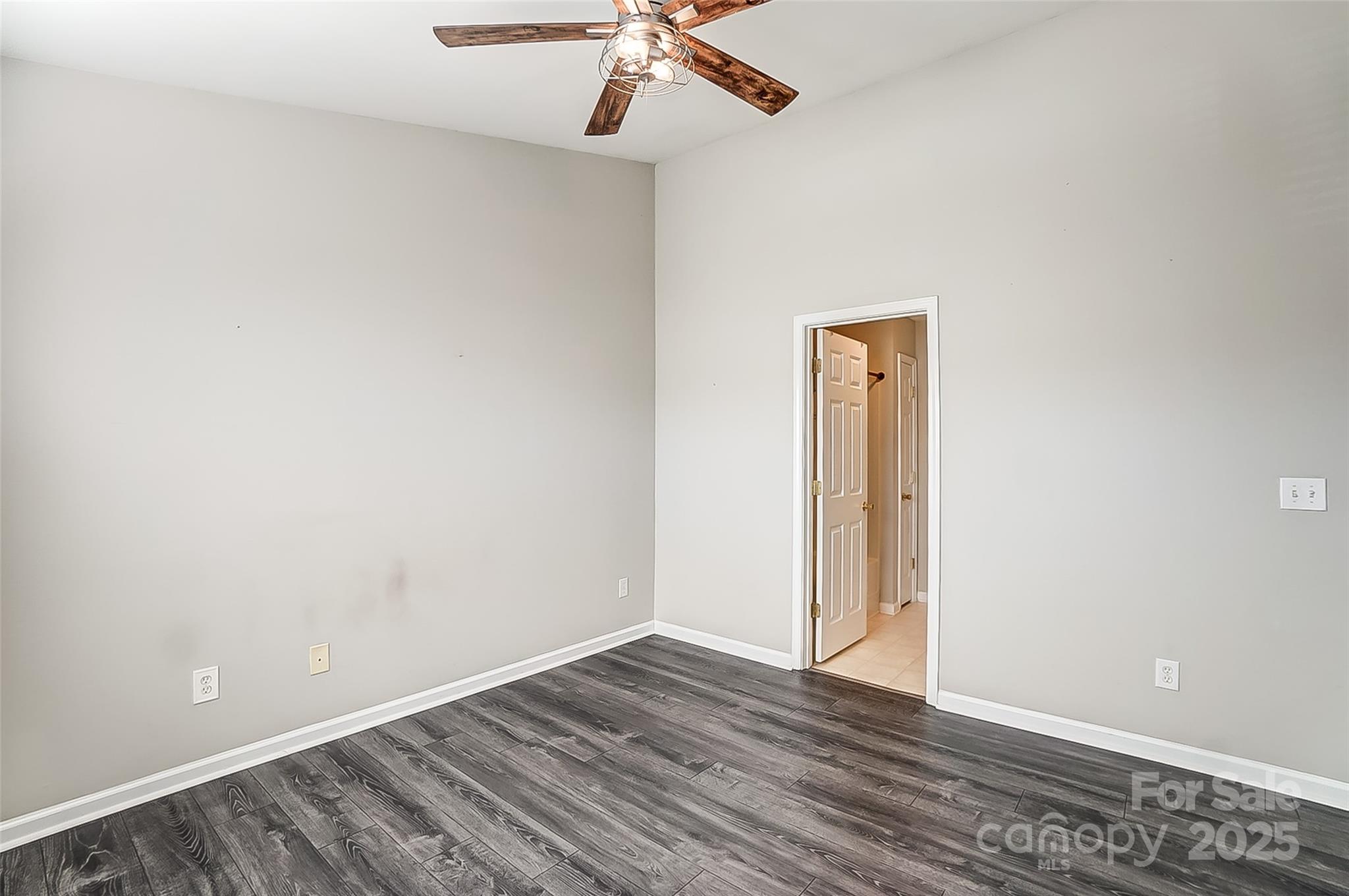 928 Azurine Circle Fort Mill, SC 29708 - Photo 25 of 33 an empty room with a ceiling fan and wooden floor
