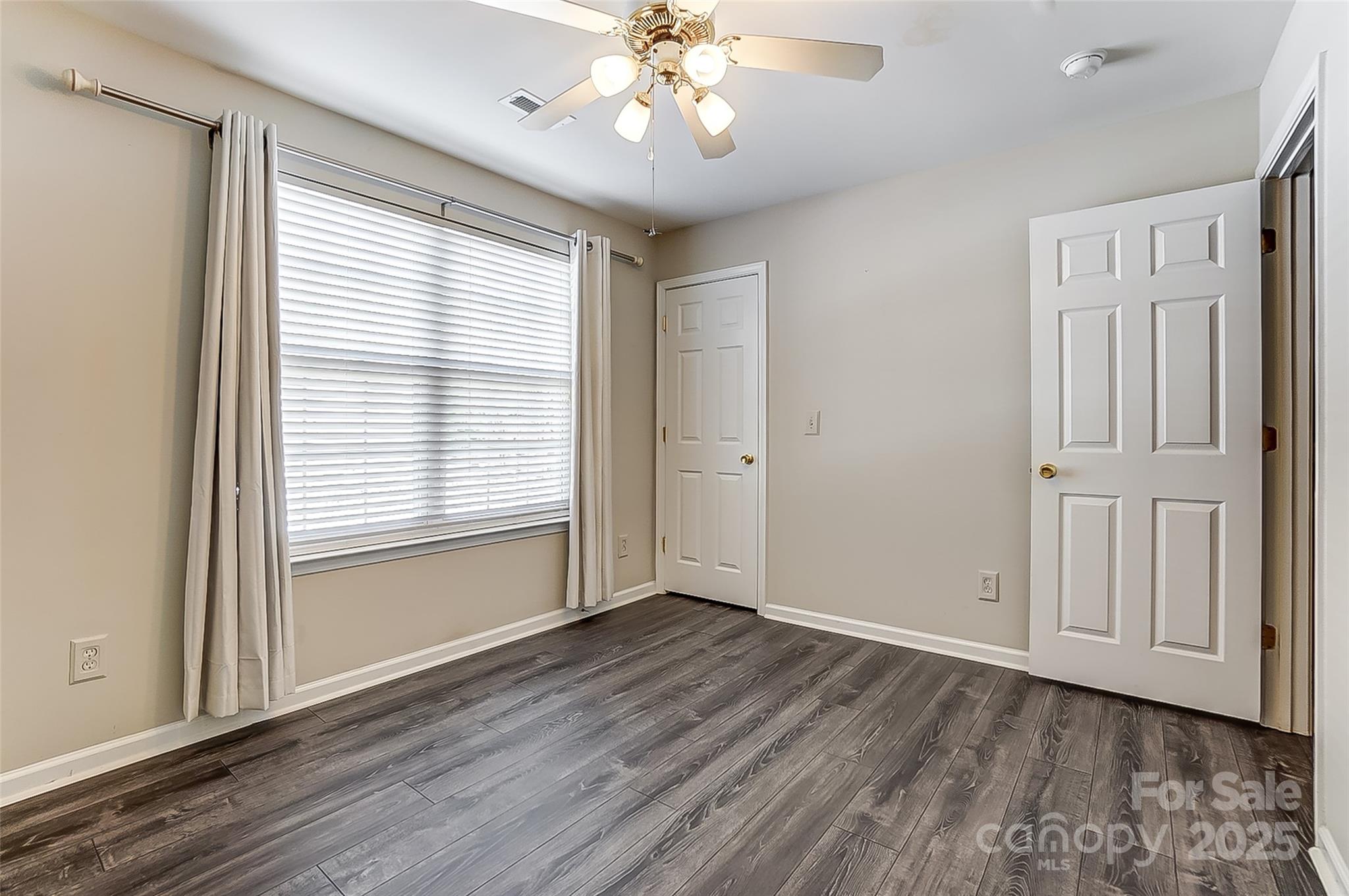 928 Azurine Circle Fort Mill, SC 29708 - Photo 30 of 33 a view of an empty room with a window and wooden floor
