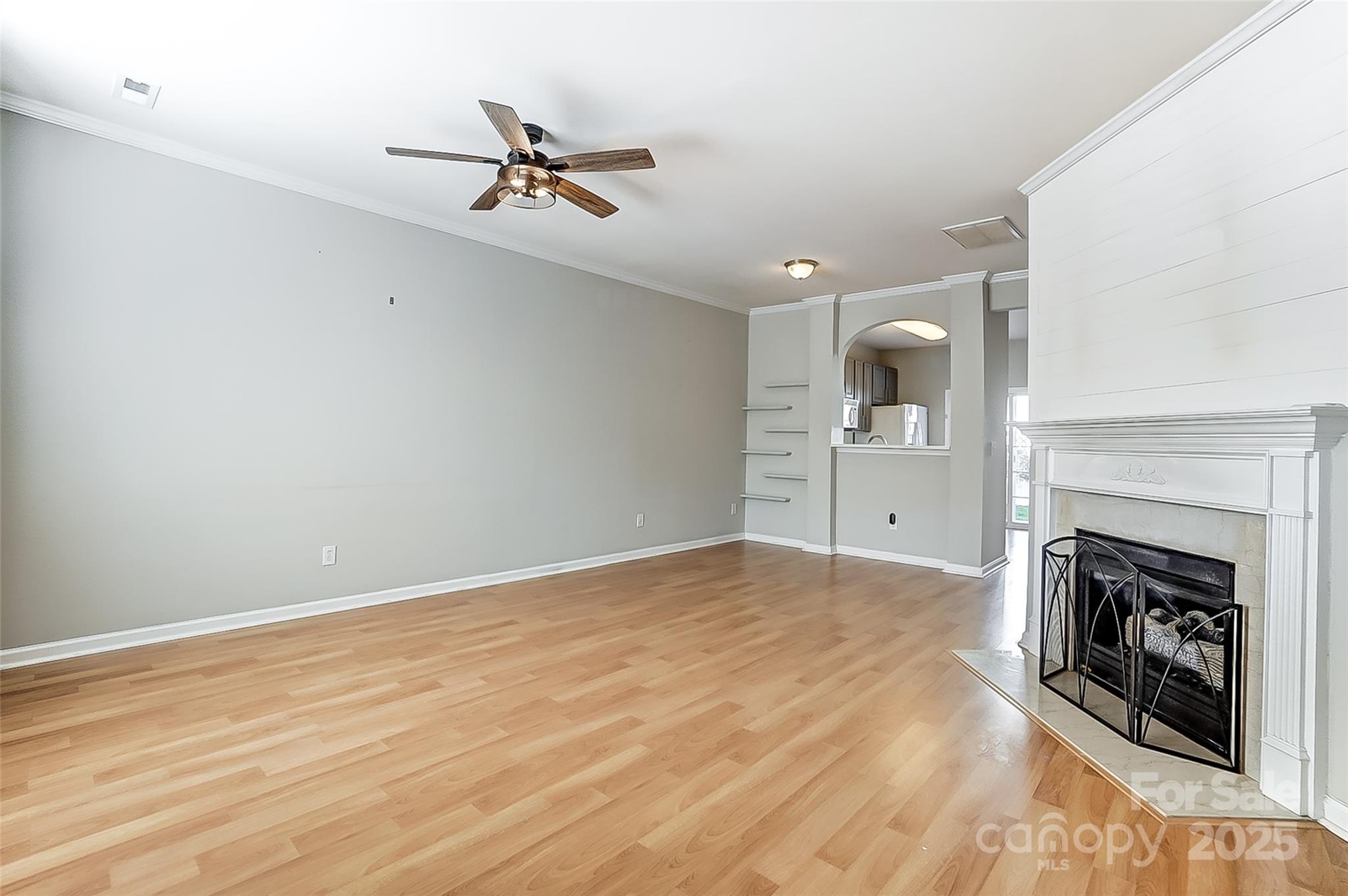 928 Azurine Circle Fort Mill, SC 29708 - Photo 6 of 33 a view of a livingroom with a fireplace a ceiling fan and wooden floor