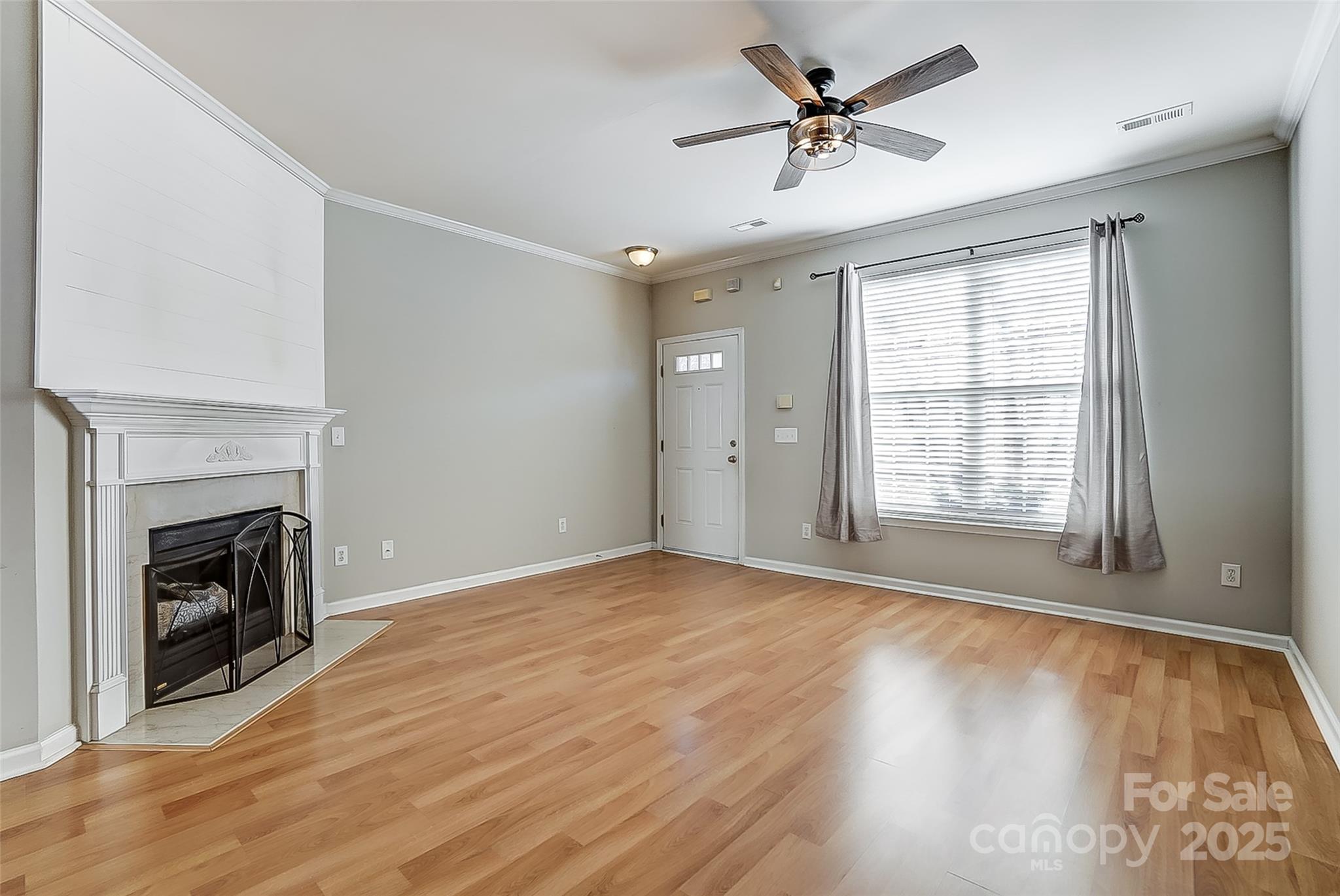 928 Azurine Circle Fort Mill, SC 29708 - Photo 8 of 33 an empty room with windows a fireplace and wooden floor