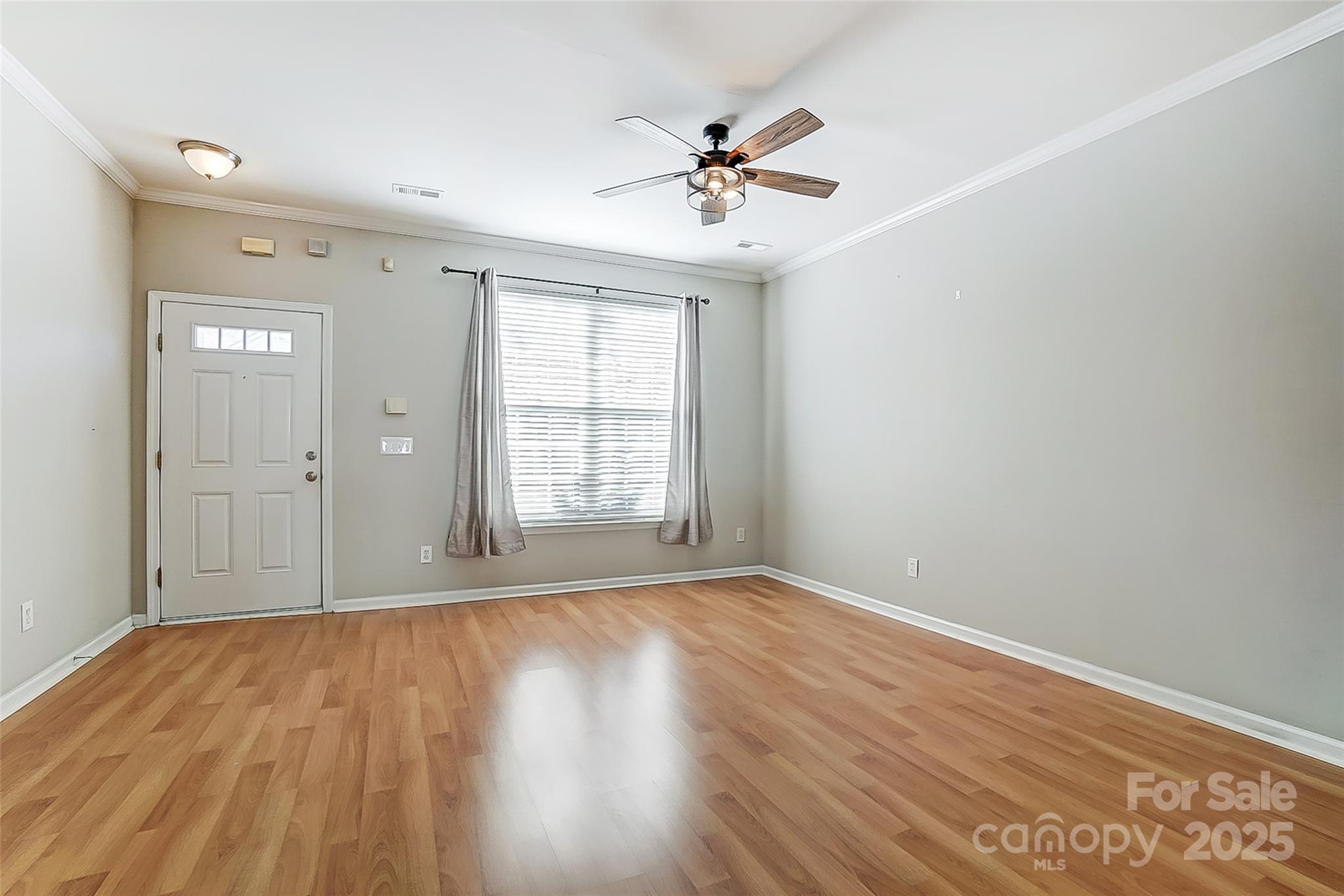 928 Azurine Circle Fort Mill, SC 29708 - Photo 9 of 33 a view of an empty room with wooden floor and a window