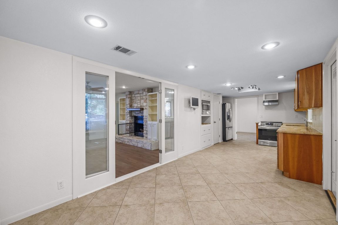 1508 Ben Crenshaw Way Austin, TX 78746 - Photo 13 of 40 a view of a kitchen with a sink and cabinets