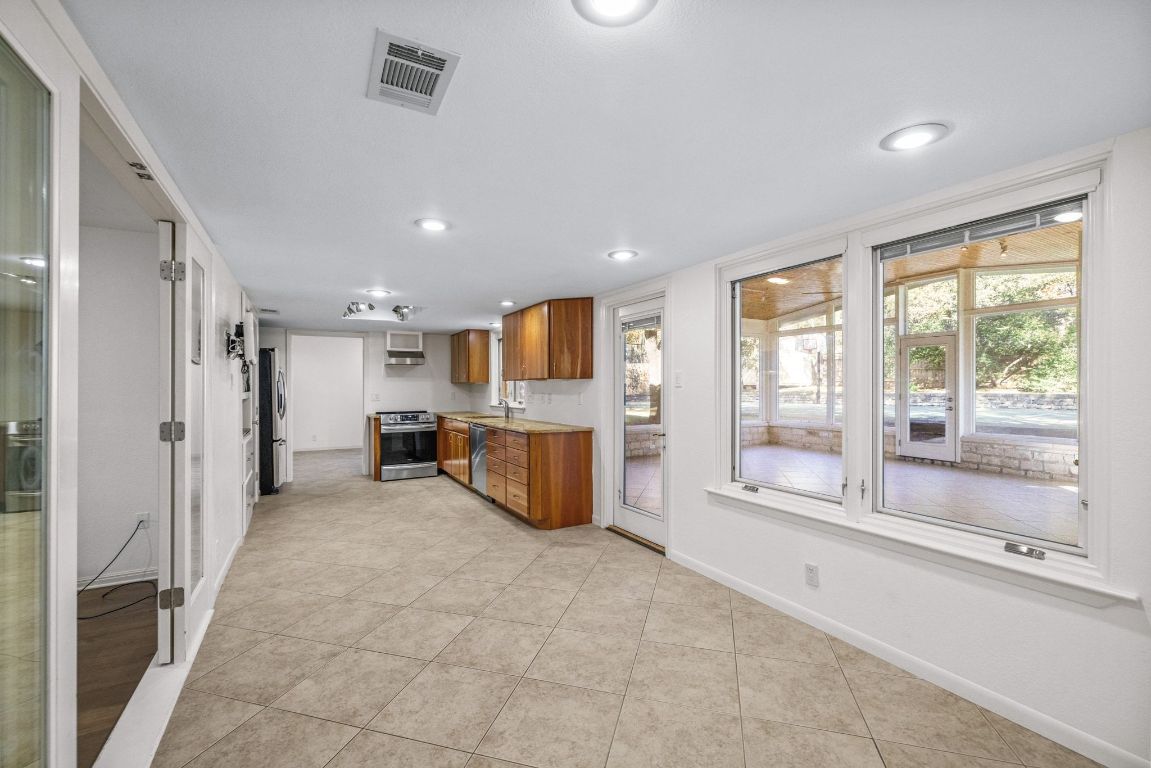 1508 Ben Crenshaw Way Austin, TX 78746 - Photo 14 of 40 a view of a kitchen with large windows