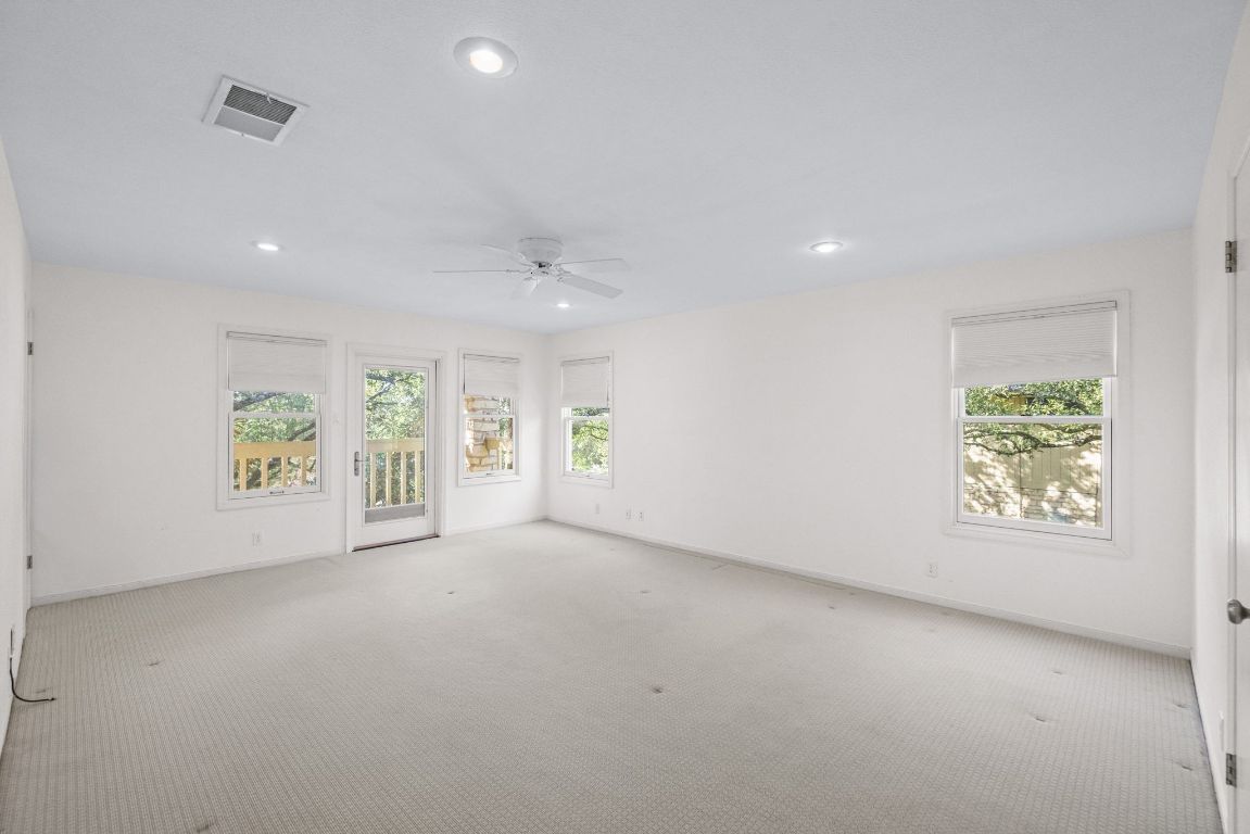 1508 Ben Crenshaw Way Austin, TX 78746 - Photo 15 of 40 an empty room with windows