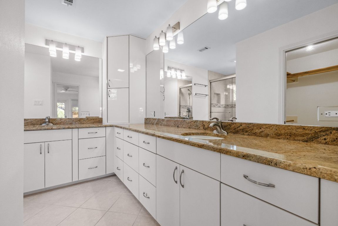 1508 Ben Crenshaw Way Austin, TX 78746 - Photo 17 of 40 a bathroom with a granite countertop double vanity sink and mirror