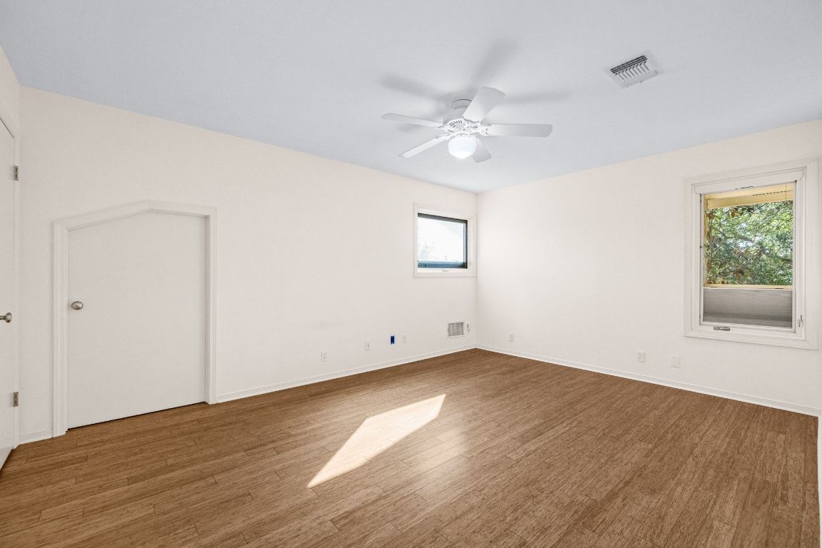 1508 Ben Crenshaw Way Austin, TX 78746 - Photo 24 of 40 a view of empty room with wooden floor and fan