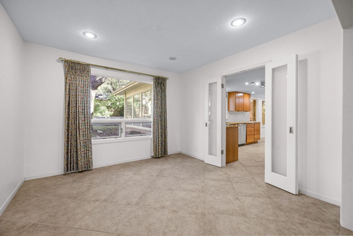 1508 Ben Crenshaw Way Austin, TX 78746 - Photo 8 of 40 an empty room with windows and entrance
