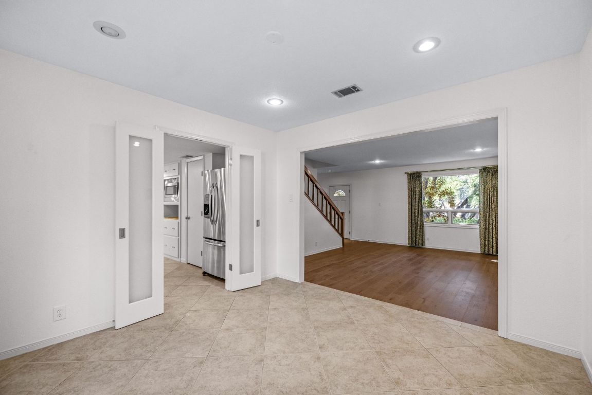 1508 Ben Crenshaw Way Austin, TX 78746 - Photo 9 of 40 an empty room with windows and entrance