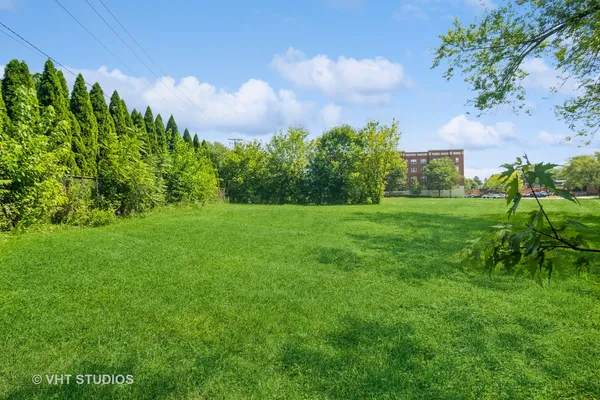 a view of a garden with a building in the background