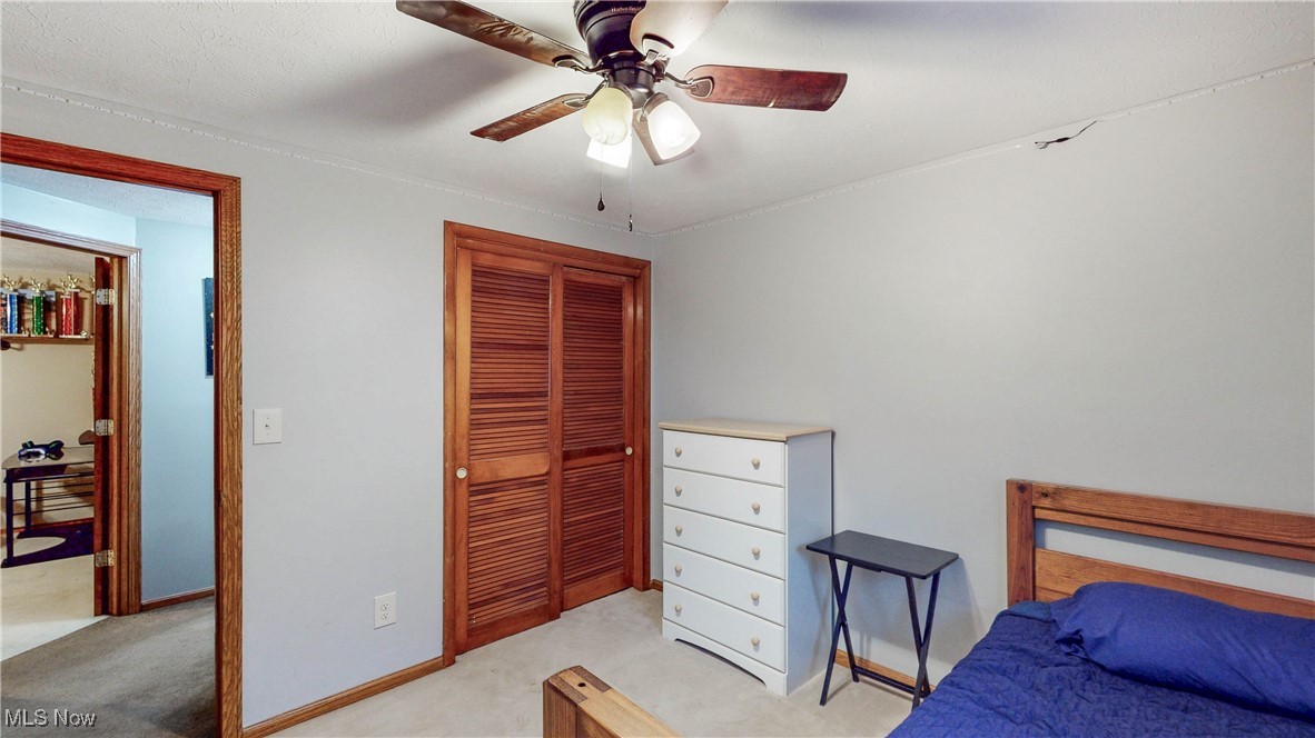 3123 Clearview Road Ravenna, OH 44266 - Photo 32 of 44 Bedroom featuring light carpet, ceiling fan, and a closet