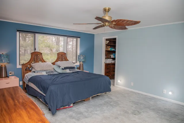a living room with furniture a flat screen tv and a large window