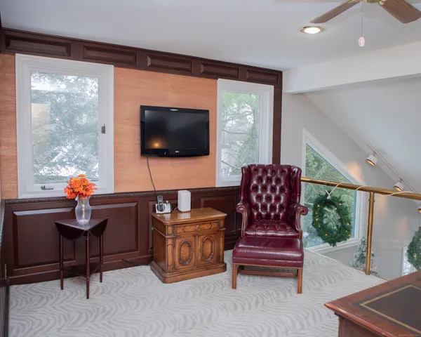 a bed sitting in a bedroom next to a larger window