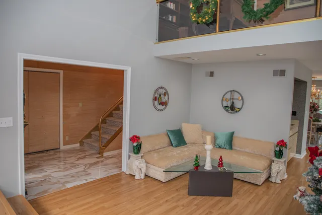 a living room with furniture and flowers