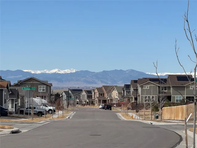 a patio with a table and chairs under an umbrella