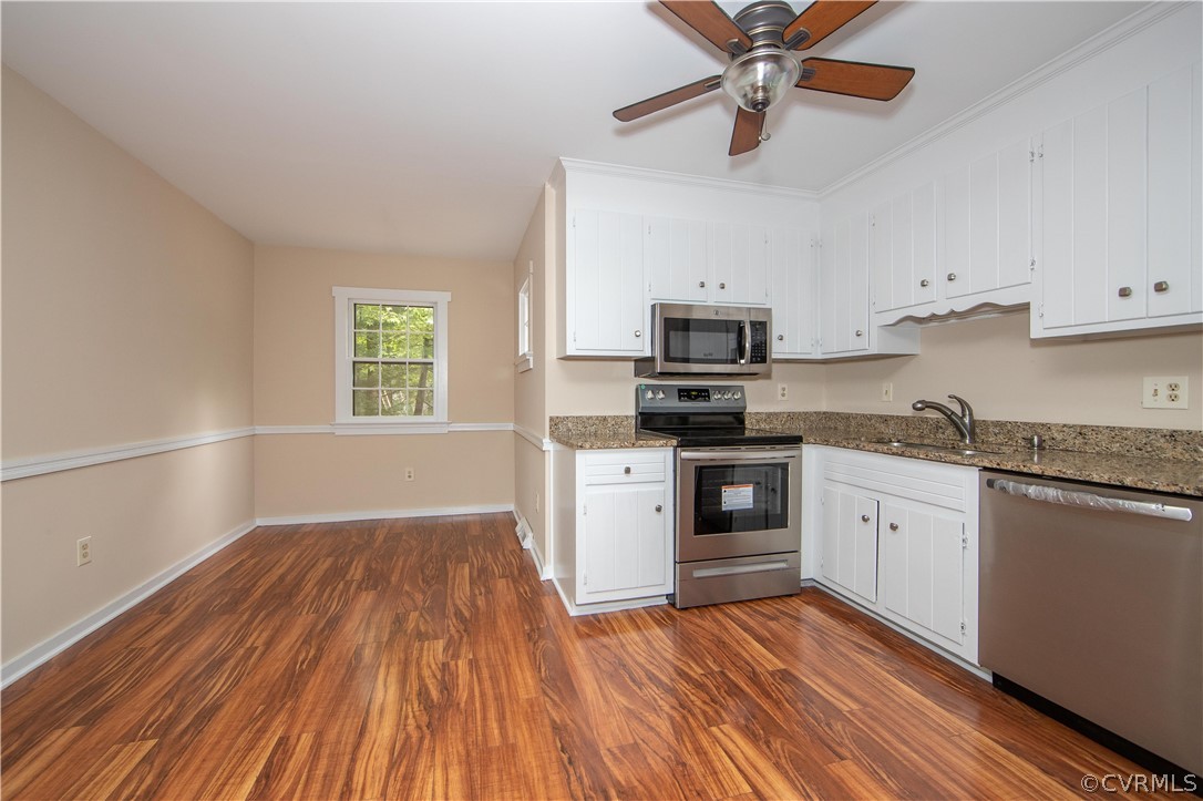 4702 Wilconna Road Chesterfield, VA 23832 - Photo 12 of 27 a kitchen with wooden floors and white appliances