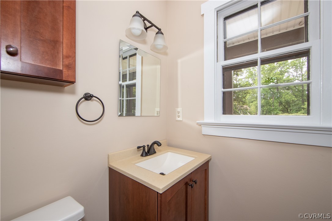 4702 Wilconna Road Chesterfield, VA 23832 - Photo 18 of 27 a bathroom with a toilet sink vanity and mirror
