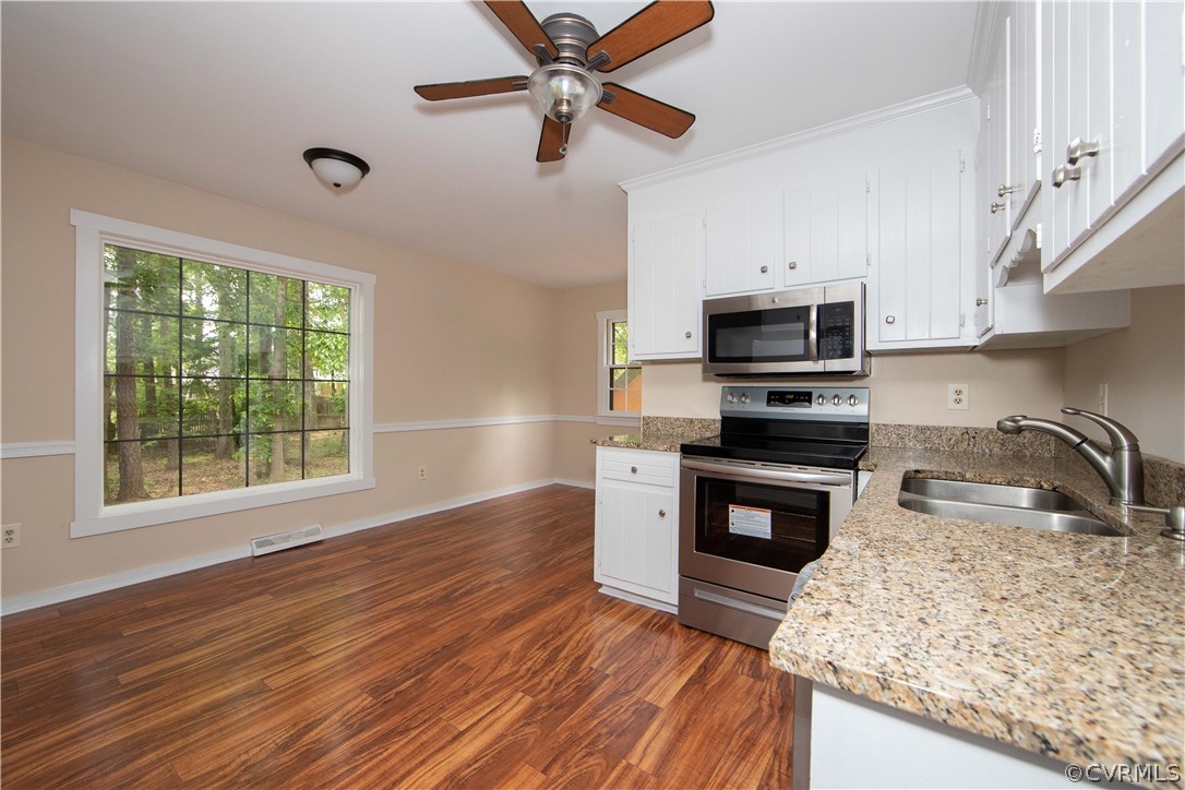 4702 Wilconna Road Chesterfield, VA 23832 - Photo 10 of 27 a kitchen with granite countertop a stove a sink and a microwave